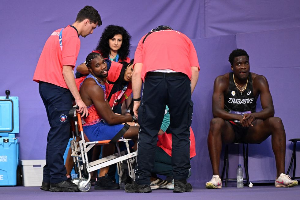 Noah Lyles received medical attention in a wheelchair