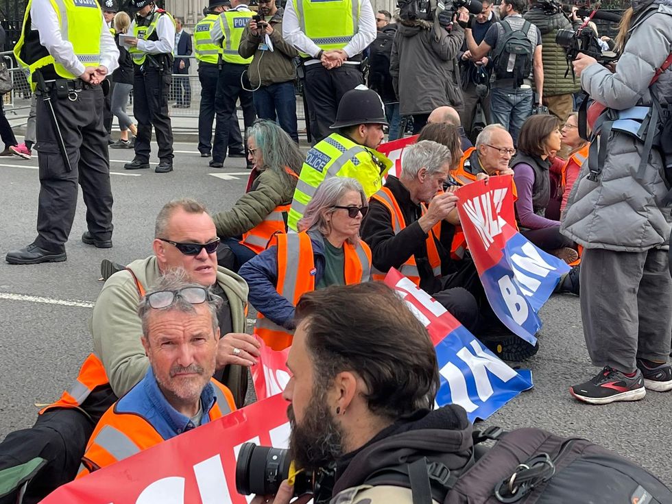 Just Stop Oil climb on police vans outside Downing St for 12th day of road-block action