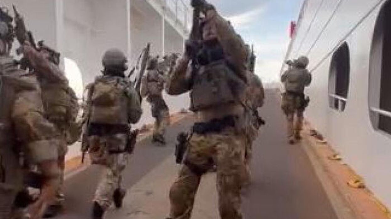 Italian special forces detain 15 migrants after they hijacked ship armed with knives