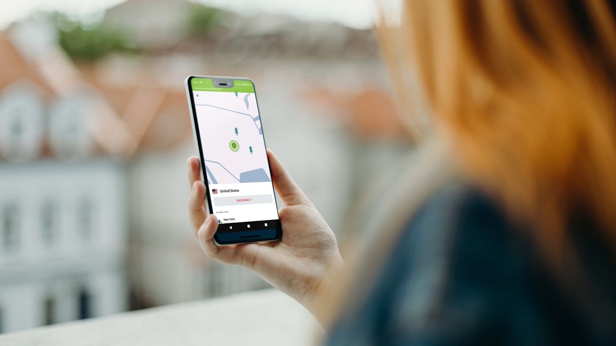 nordvpn pictured running on an android smartphone held in the hand of a ginger woman