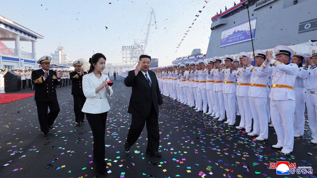 North Korean leader Kim Jong Un, accompanied by his daughter Kim Ju Ae, attends a ceremony for the launch of a "new multipurpose destroyer,