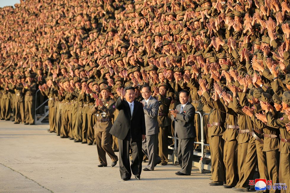 North Korean leader Kim Jong Un greets military members on the 73rd anniversary of the country's founding, in Pyongyang, in this undated image supplied by North Korea's Korean Central News Agency on September 9, 2021.