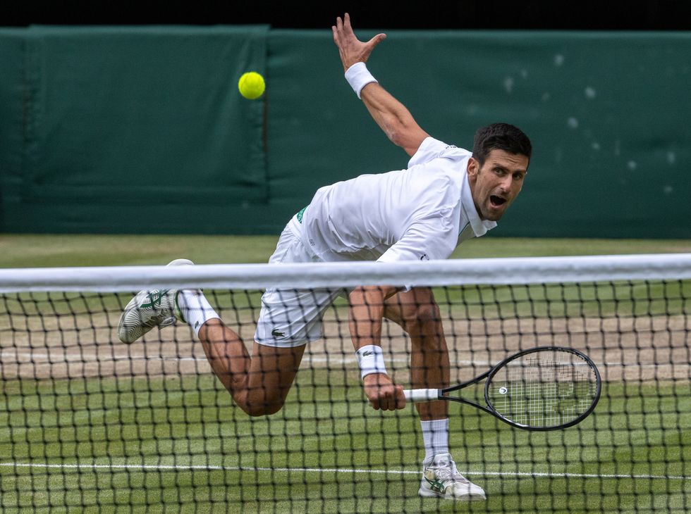 Novak Djokovic in action against Denis Shapovalov in the mens' singles semi-final on centre court on day eleven of Wimbledon at The All England Lawn Tennis and Croquet Club, Wimbledon. Picture date: Friday July 9, 2021.