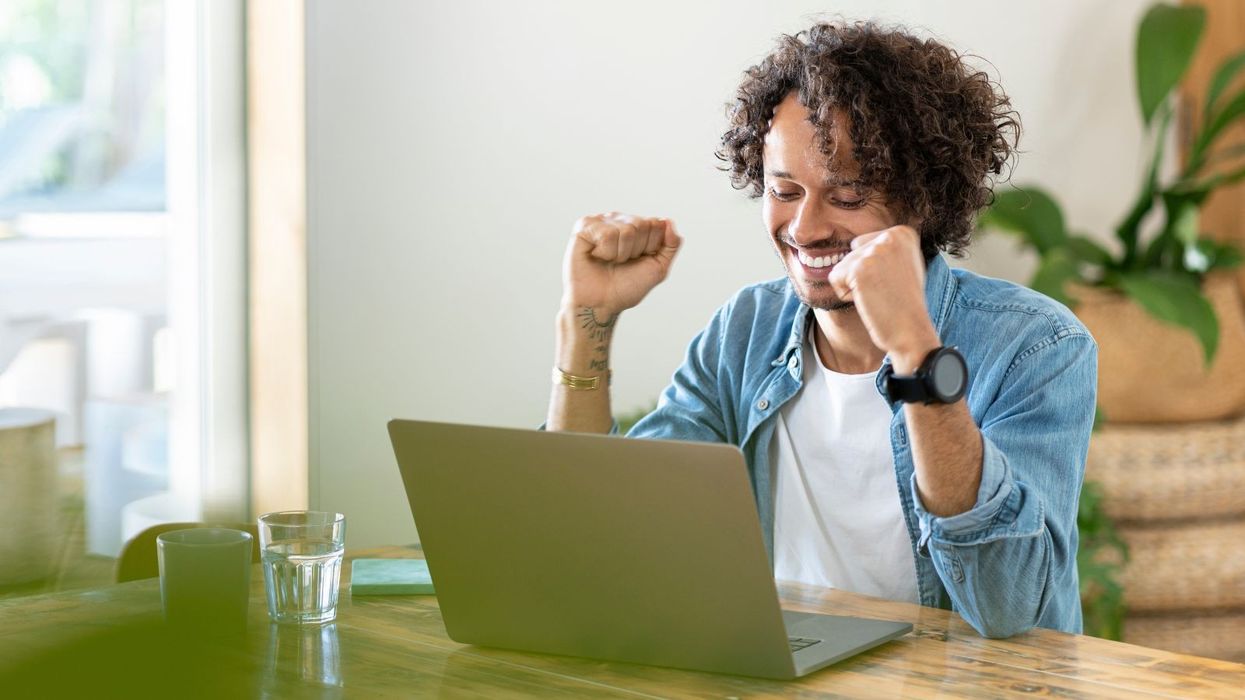 NS&I saver looks happy at laptop