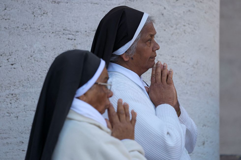 Nuns pray as faithful attend the funeral Mass of Pope Francis in St. Peter's Square