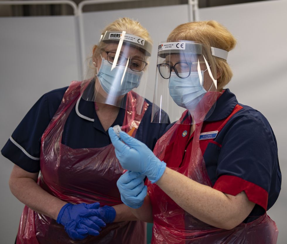 Nurses at the Northern General Hospital, Sheffield, preparing the first COVID Pfizer vaccine doses, on the first day of the largest immunisation programme in the UK's history. Care home workers, NHS staff and people aged 80 and over began receiving the jab this morning.