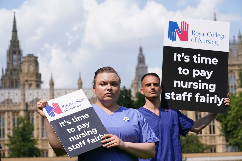Nurses with placards outside the Royal College of Nursing (RCN) in London.