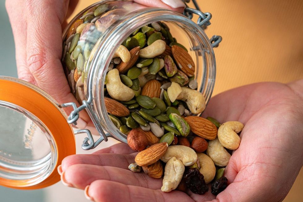 NUT SELECTIONS BEING POURED INTO HAND