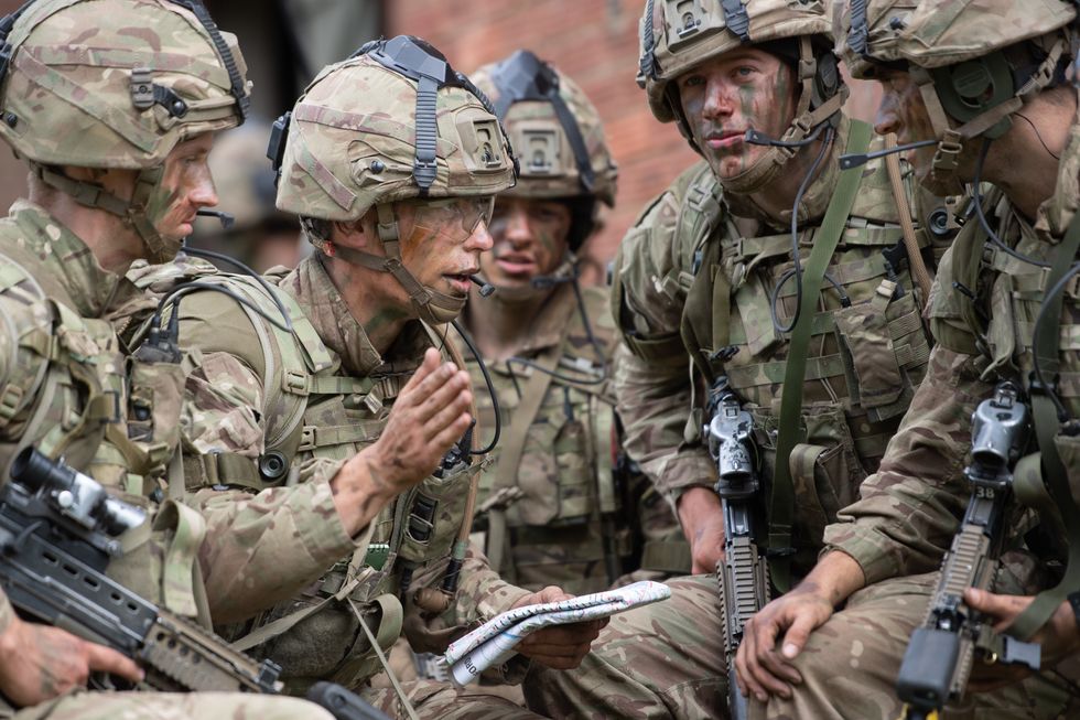 Officer cadets launch a platoon attack on a compound in West Tofts Camp, Thetford, Norfolk, during the British Army Exercise Dynamic Victory which is usually held overseas with alongside coalition forces but is taking place in UK due to Covid-19 restrictions.