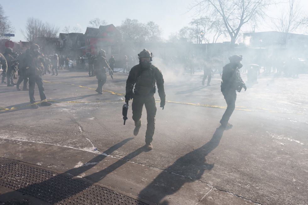 Officers walk through tear gas in Minneapolis