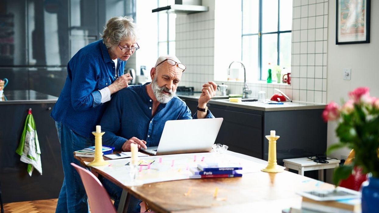 Old couple booking holiday