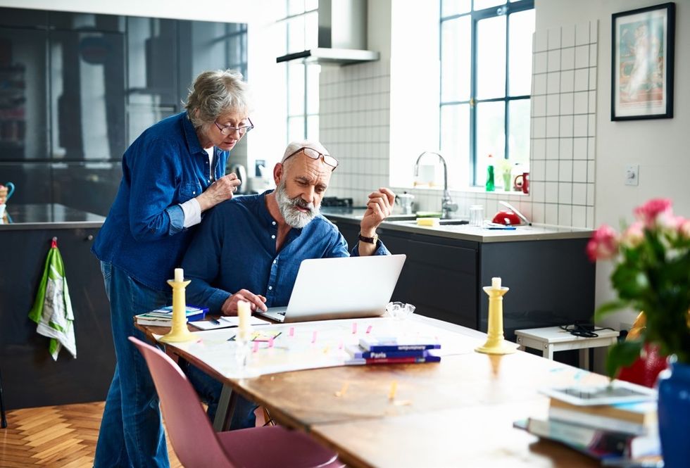 Old couple booking holiday
