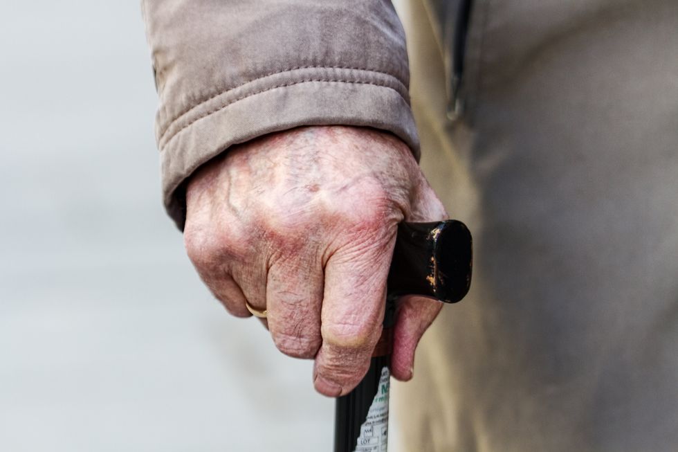 OLD HAND WITH WALKING STICK