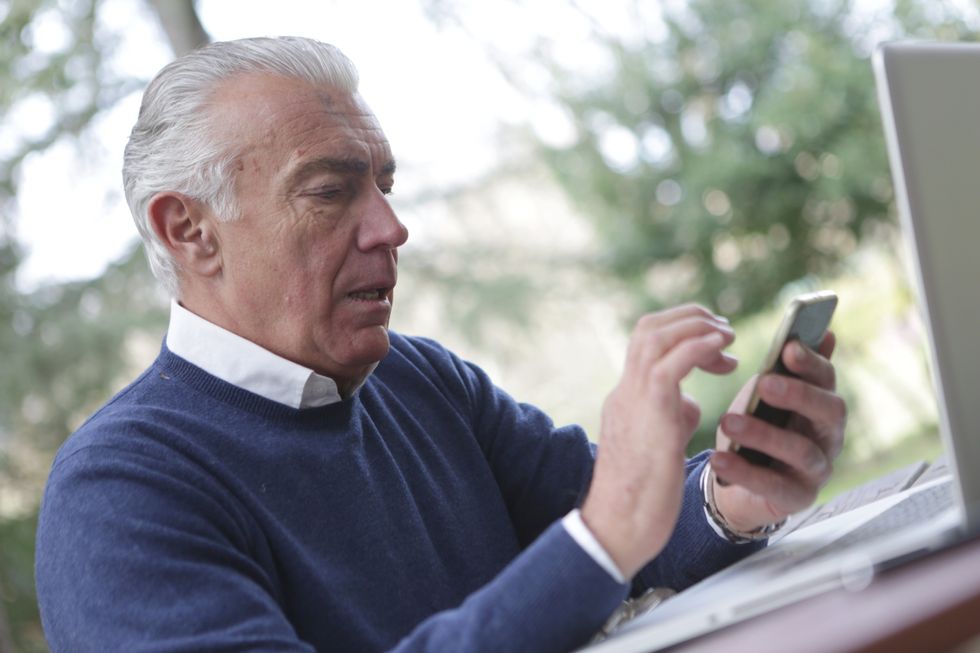 Old person looking at his phone