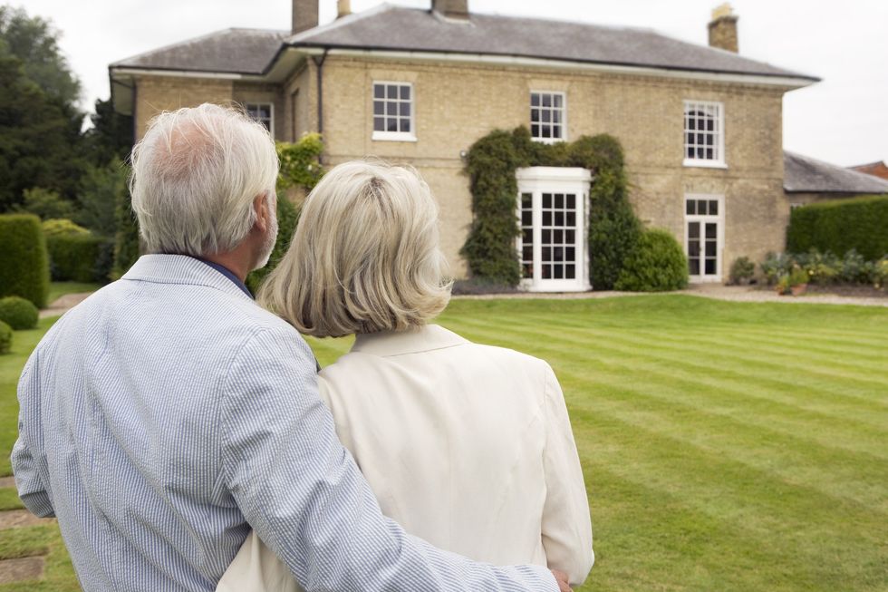 Older couple looking at their large house