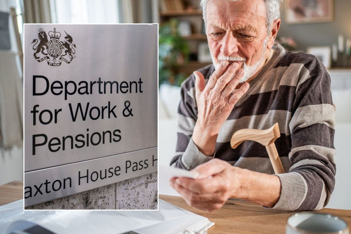 Older man looking at letter and DWP sign