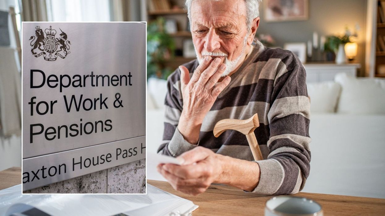 Older man looking at letter and DWP sign