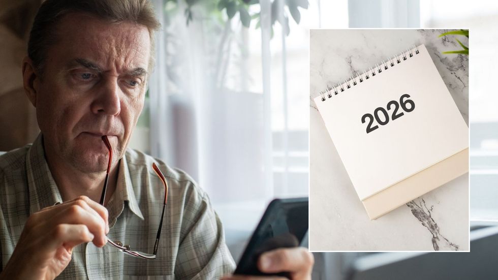 Older man looking at phone and 2026 calendar