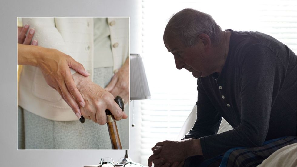 Older man looking worried and carer looking after older woman