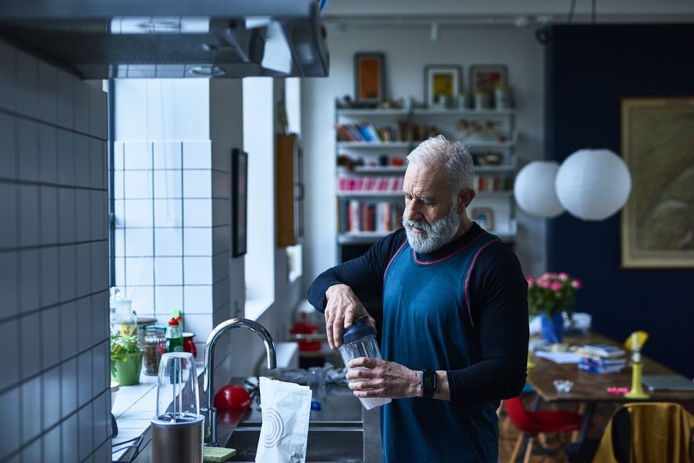 Older man making protein shake