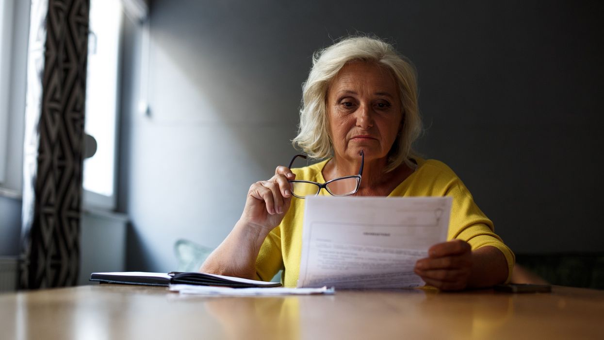 Older woman looking at form