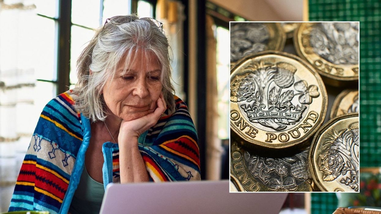 Older woman looking at laptop and pound coins