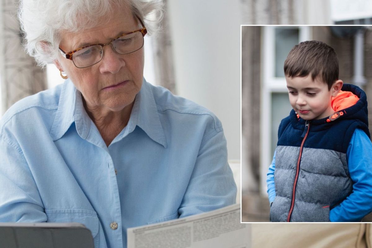 Older woman looking at letter and wee boy