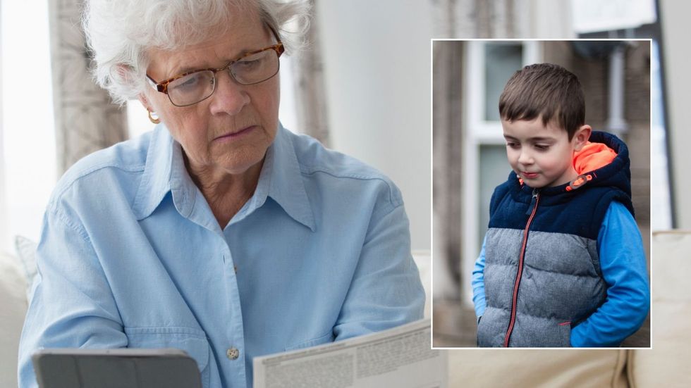 Older woman looking at letter and wee boy