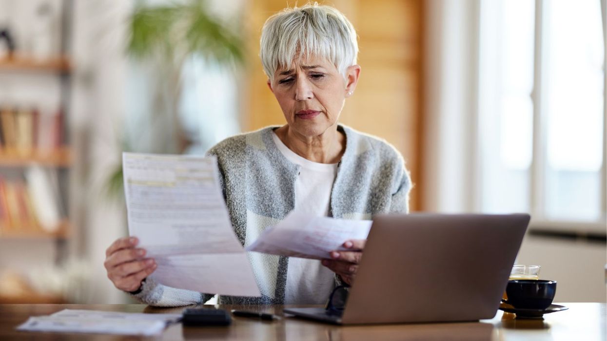 Older woman looking worried at documents