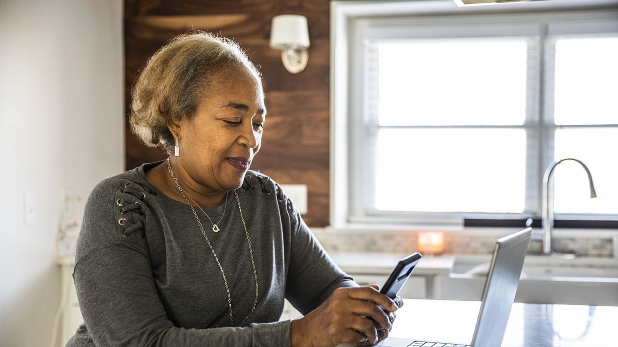 Older woman on phone and laptop