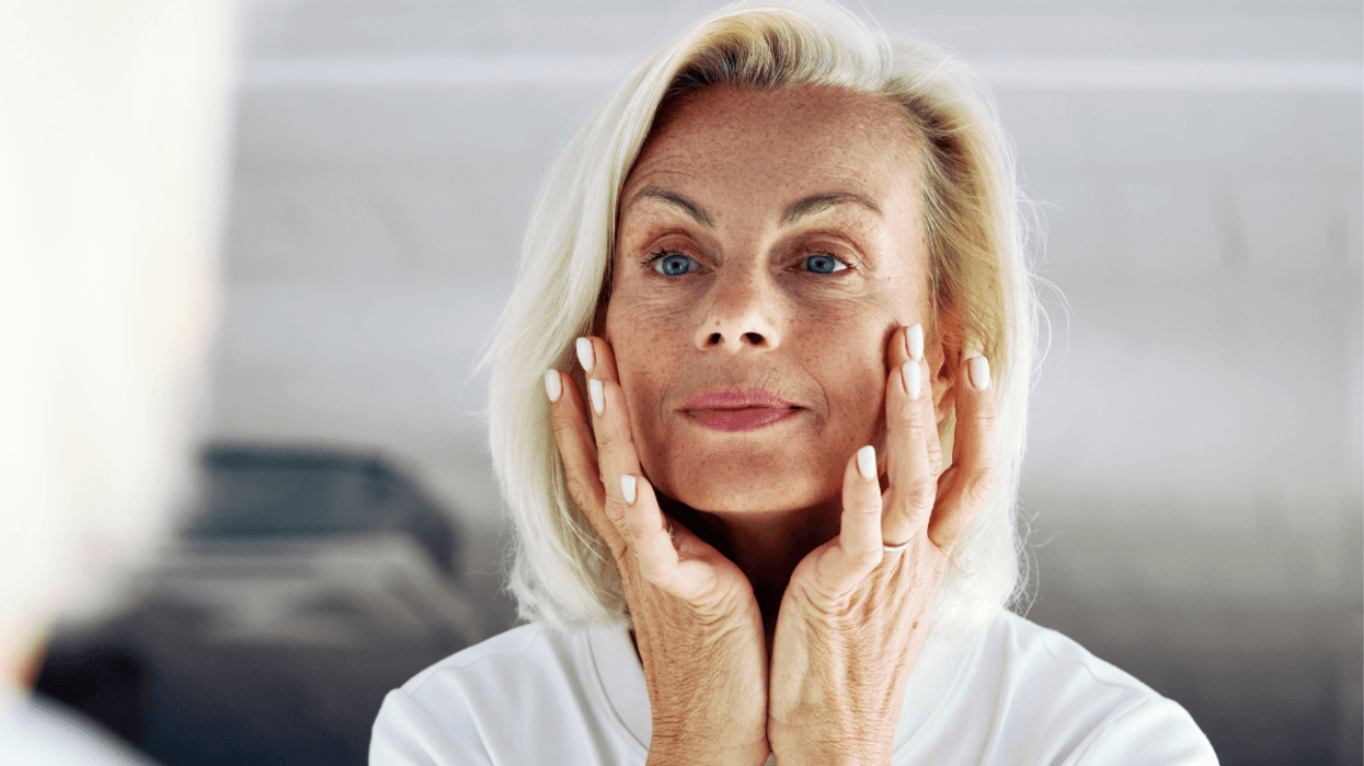 Older woman touching face