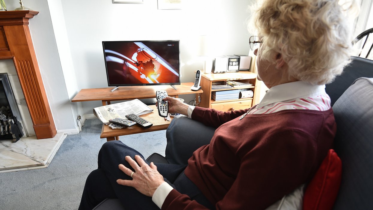 Older woman watching BBC on TV