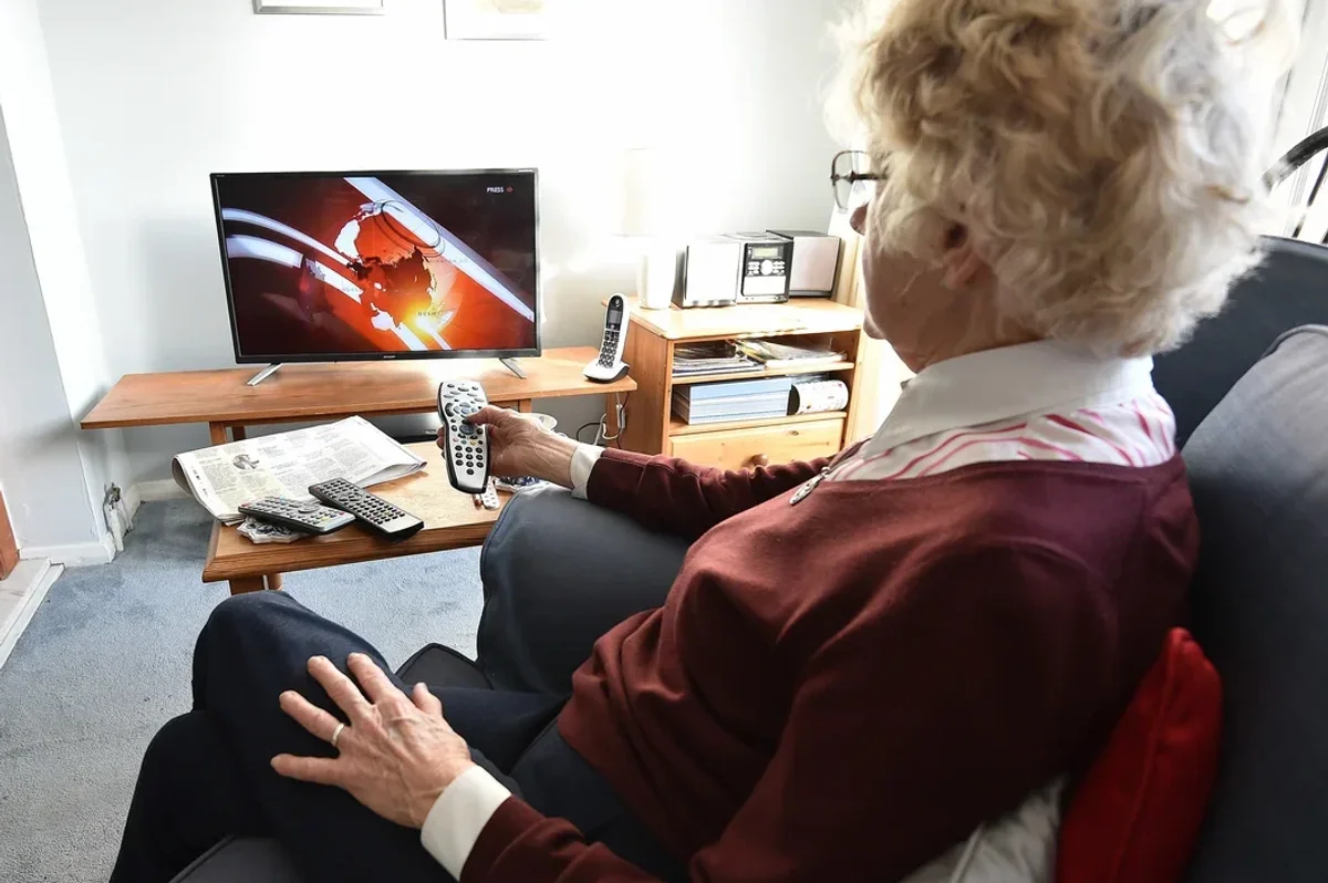 Older woman watching tv