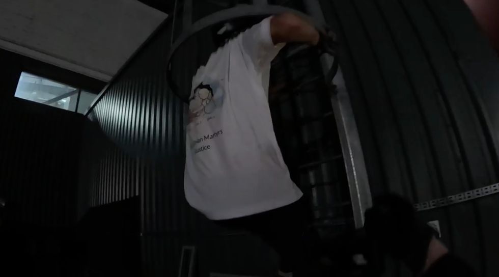 One activist climbing the roof