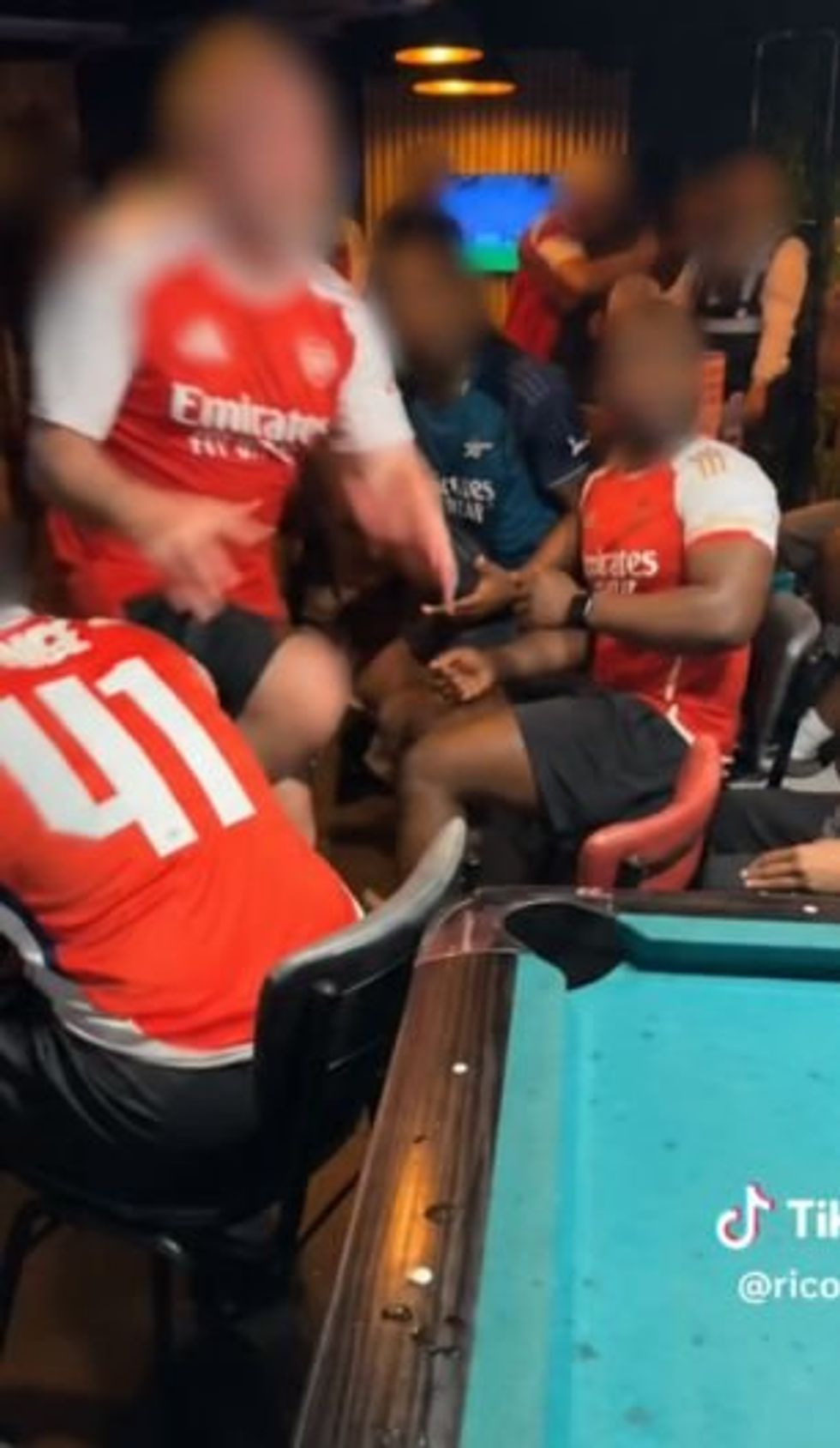 One Arsenal fan jumped across a pool table to start a fight in the closing stages of the Gunners' Champions League final with PSG