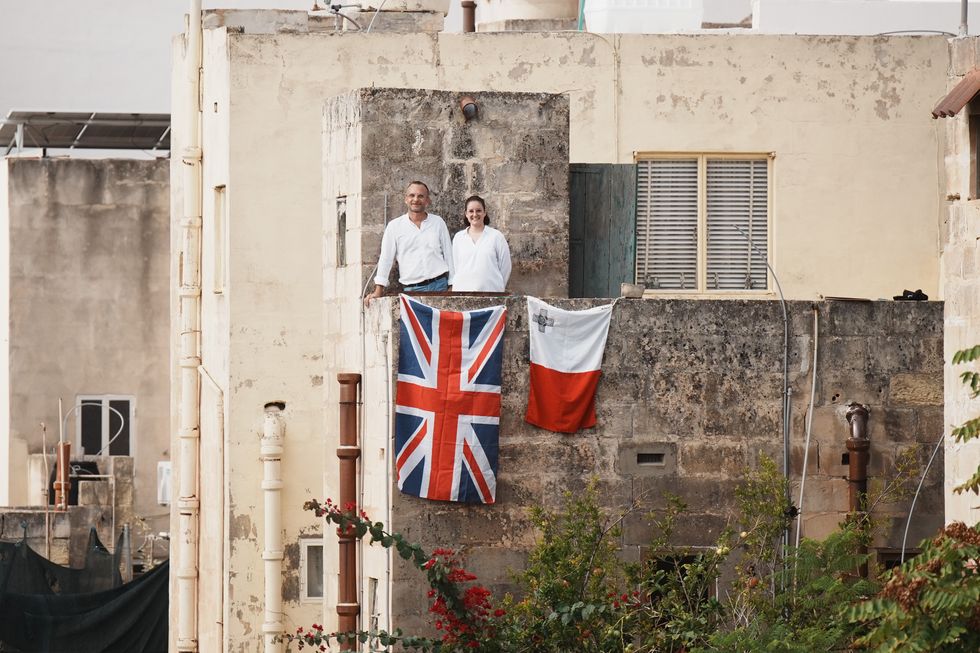 Onlookers wait for the Duke and Duchess of Edinburgh in Malta