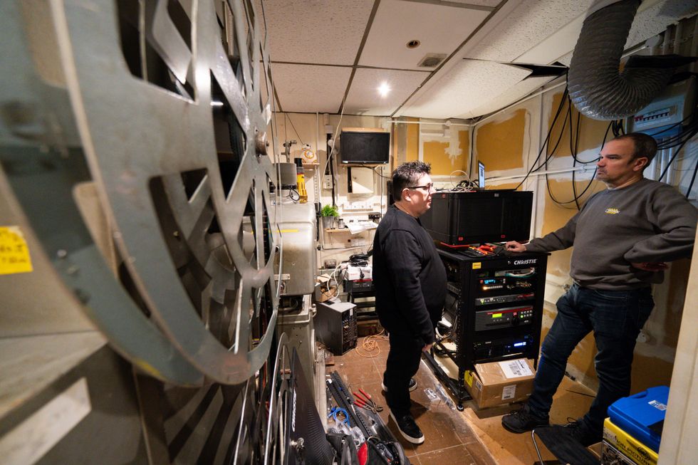 Owner Kevin Markwick and an engineer working in the projection booth ahead of the reopening of The Electric Cinema in Birmingham, which was forced to close permanently during the pandemic but is now back in use. The 112-year-old art deco cinema, built in a converted taxi rank, began operating in December 1909 and is believed to be the oldest working cinema in the UK. Picture date: Tuesday January 18, 2022.