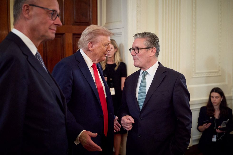 P\u200bresident Donald Trump talks with Prime Minister Keir Starmer next to German Chancellor Friedrich Merz