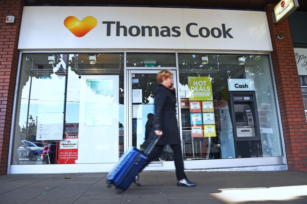 PA file photo of a woman walking past a Thomas Cook high street store.See PA Feature TOPICAL Travel Package. Picture credit should read: Kirsty O'Connor/PA. WARNING: This picture must only be used to accompany PA Feature TOPICAL Travel Package.