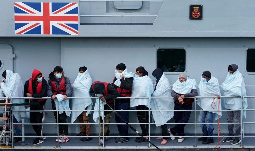 PA REVIEW OF THE YEAR 2022 File photo dated 15/03/22 - A group of people thought to be migrants are brought in to Dover, Kent, onboard a Border Force vessel following a small boat incident in the Channel. Issue date: Tuesday December 20, 2022.