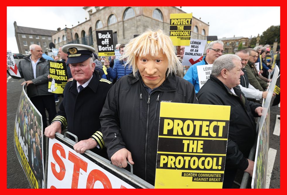 PABest A man dressed as a customs officer and another dressed as Boris Johnson with protesters from Border Communities Against Brexit outside Hillsborough Castle during a visit by Prime Minister Boris Johnson to Northern Ireland for talks with Stormont parties. Picture date: Monday May 16, 2022.