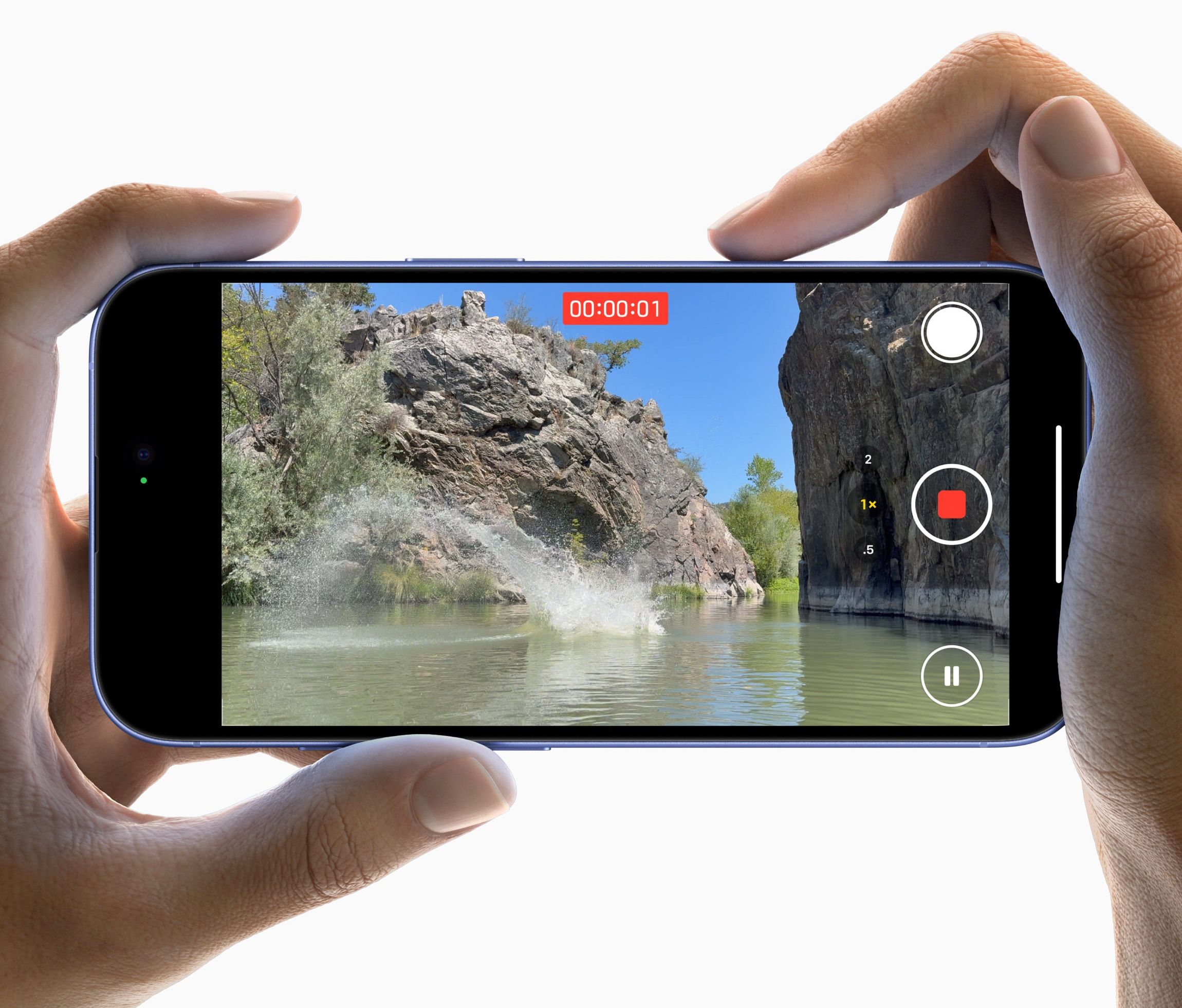 pair of hands pictured holding the iphone 16 using the camera control button