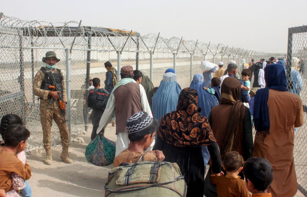 Pakistan Army soldier stands guard as people cross into Afghanistan, at the Friendship Gate crossing point at the Pakistan-Afghanistan border town of Chaman, Pakistan August 16, 2021.