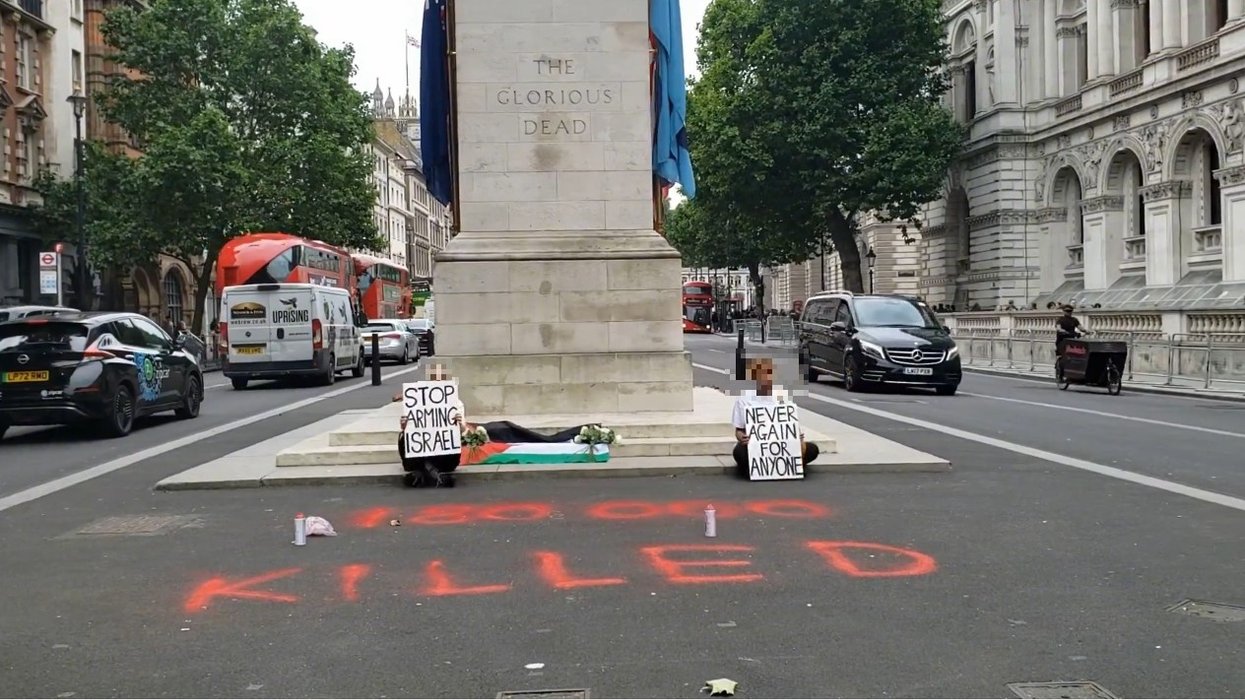 Palestine protesters drape flag over steps of Cenotaph and spray graffiti on road