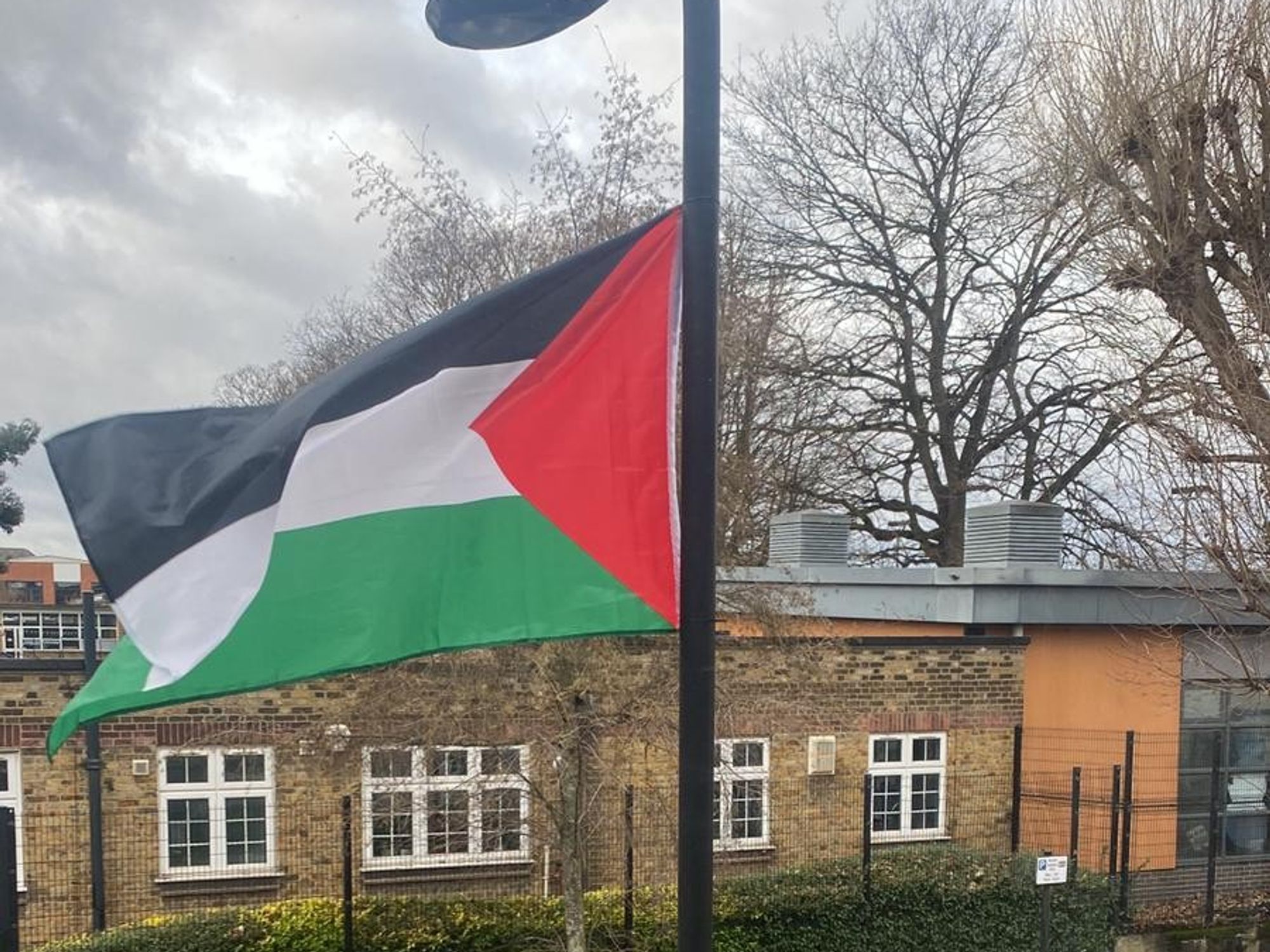 Palestinian flag hoisted outside school