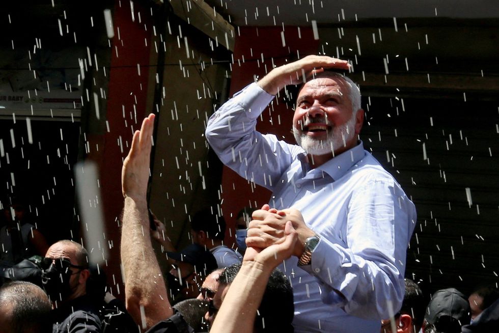 Palestinian group Hamas' top leader, Ismail Haniyeh, looks on as he is carried during his visit at Ain el Hilweh Palestinian refugee camp in Sidon, Lebanon