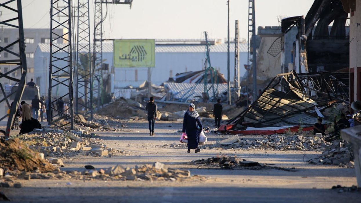 Palestinians take to the road in Al-Maghazi as they flee their displacement camps