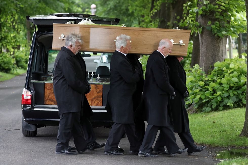 Pall-bearers carry the coffin of Jeremy Kyle guest Steve Dymond during his funeral