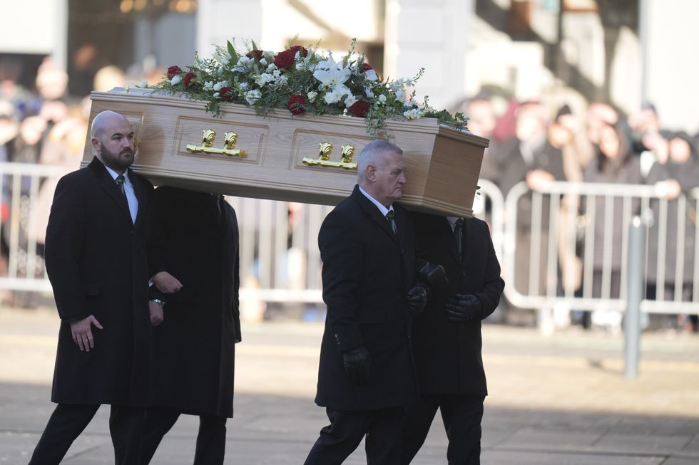 Pallbearers carry John Prescott's coffin