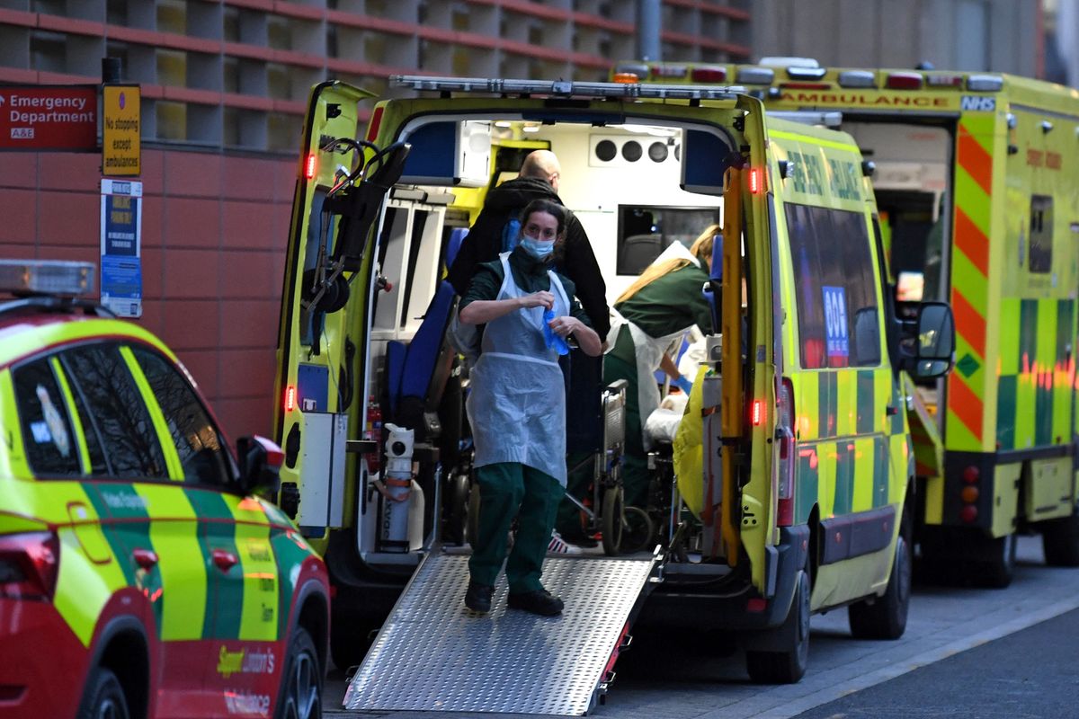 Paramedics work inside an ambulance parked outside the Royal London Hospital